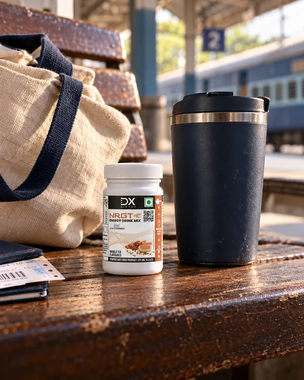 Masala Tea jar and a travel mug beside a bag at a railway platform