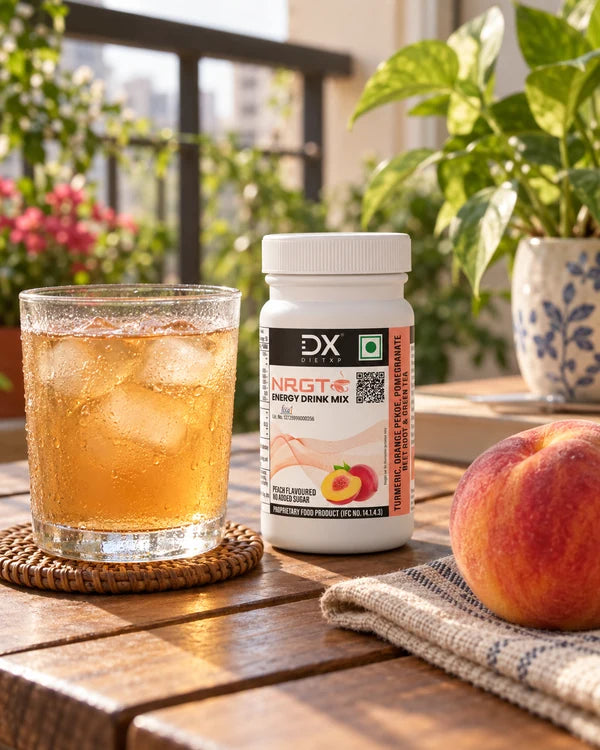 A glass of iced tea and small NRGT Peach jar on a balcony table