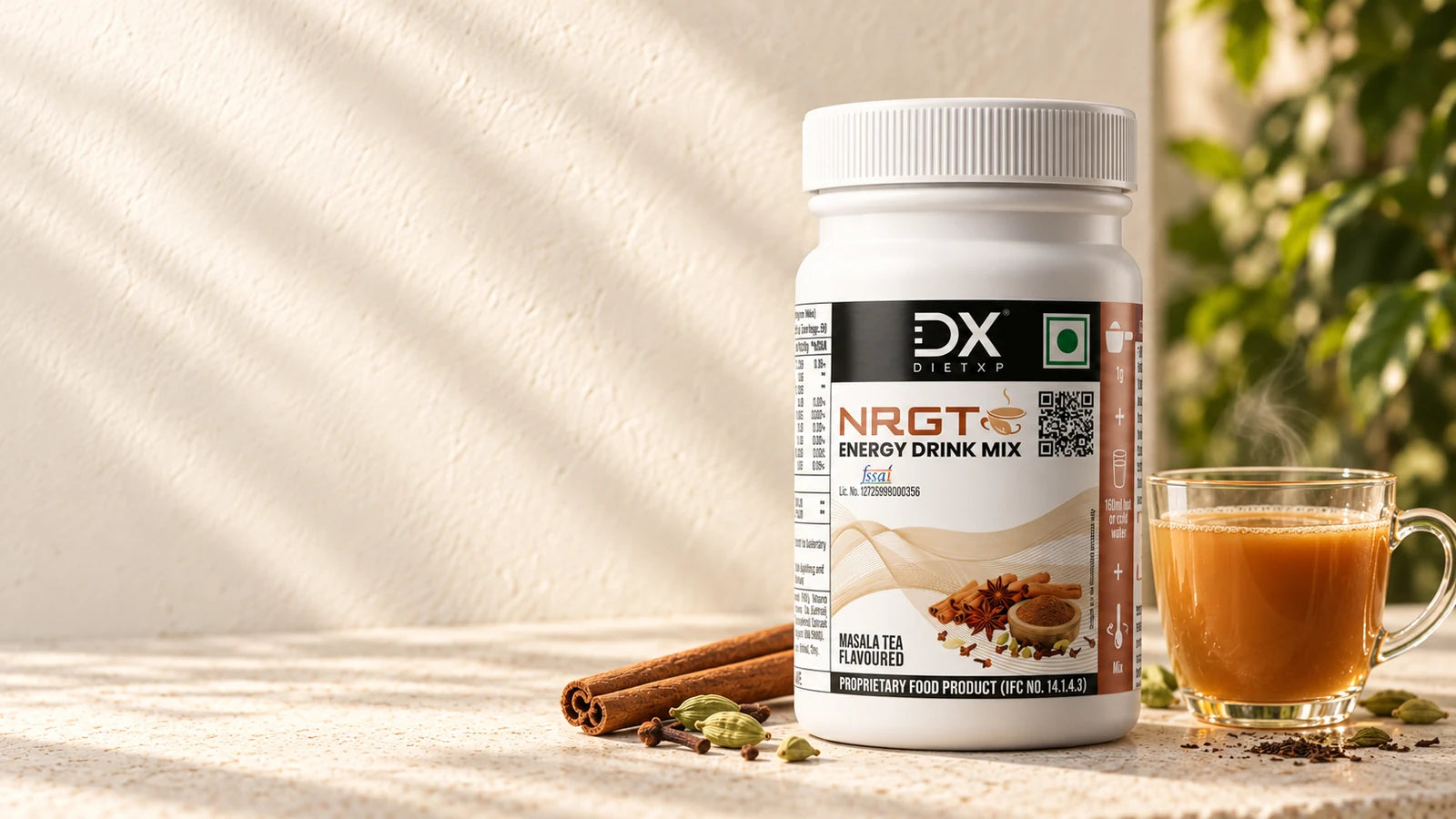 DietXP NRGT Masala Tea jar beside a cup of tea and aromatic spices